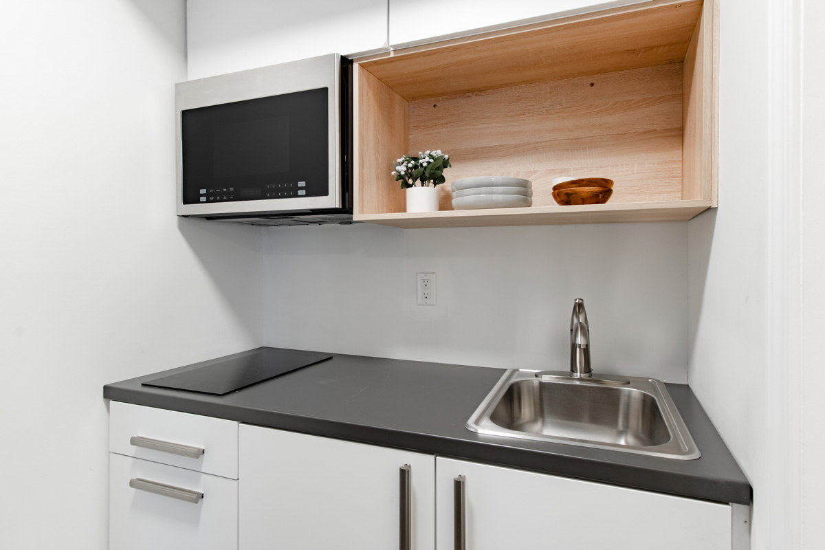 Studio kitchenette with microwave and stovetop